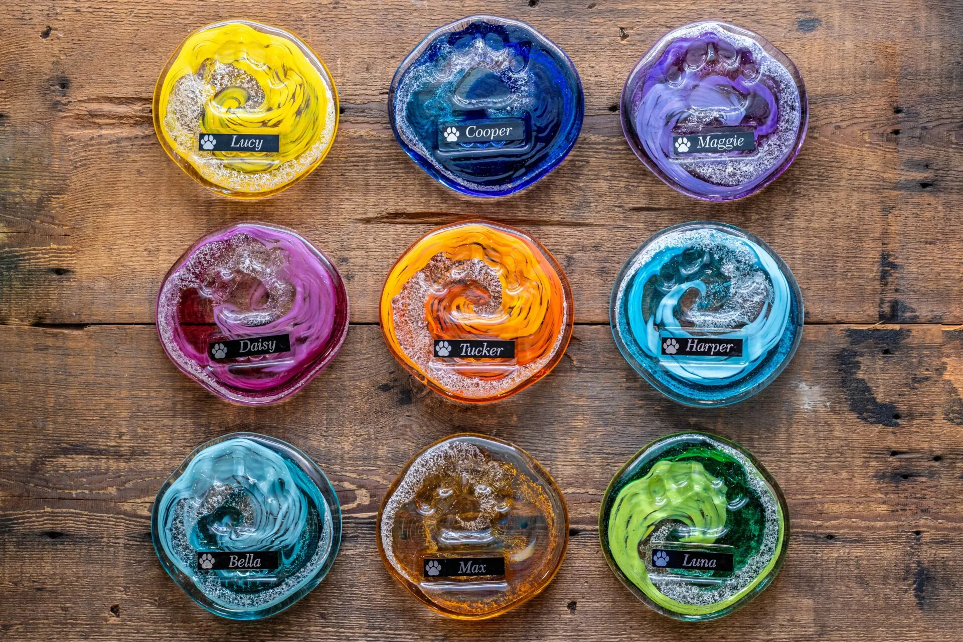 seven different colored soaps in glass bowls