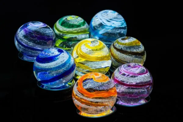 a group of colorful glass balls sitting on top of a table