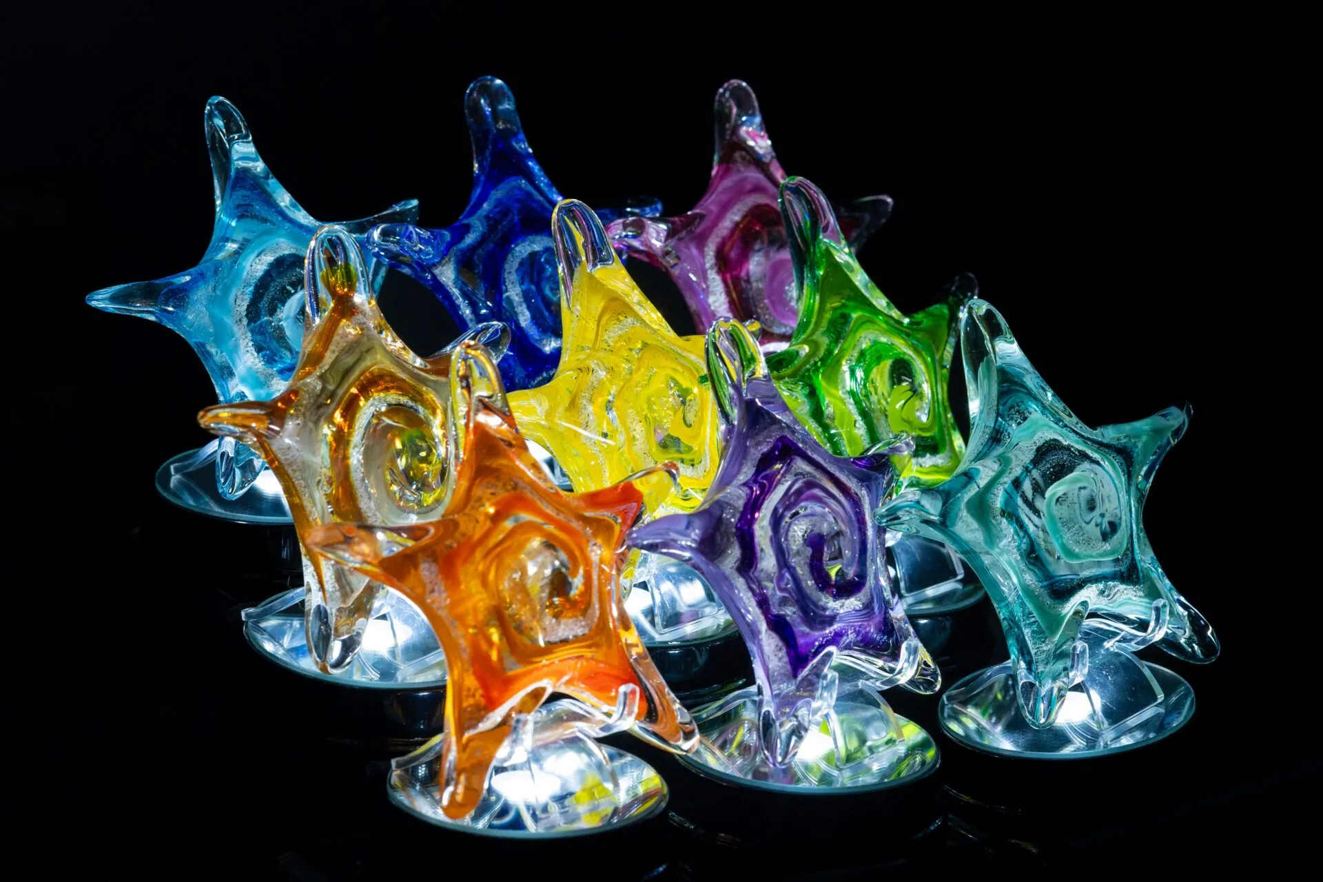 a group of colorful glass stars sitting on top of each other