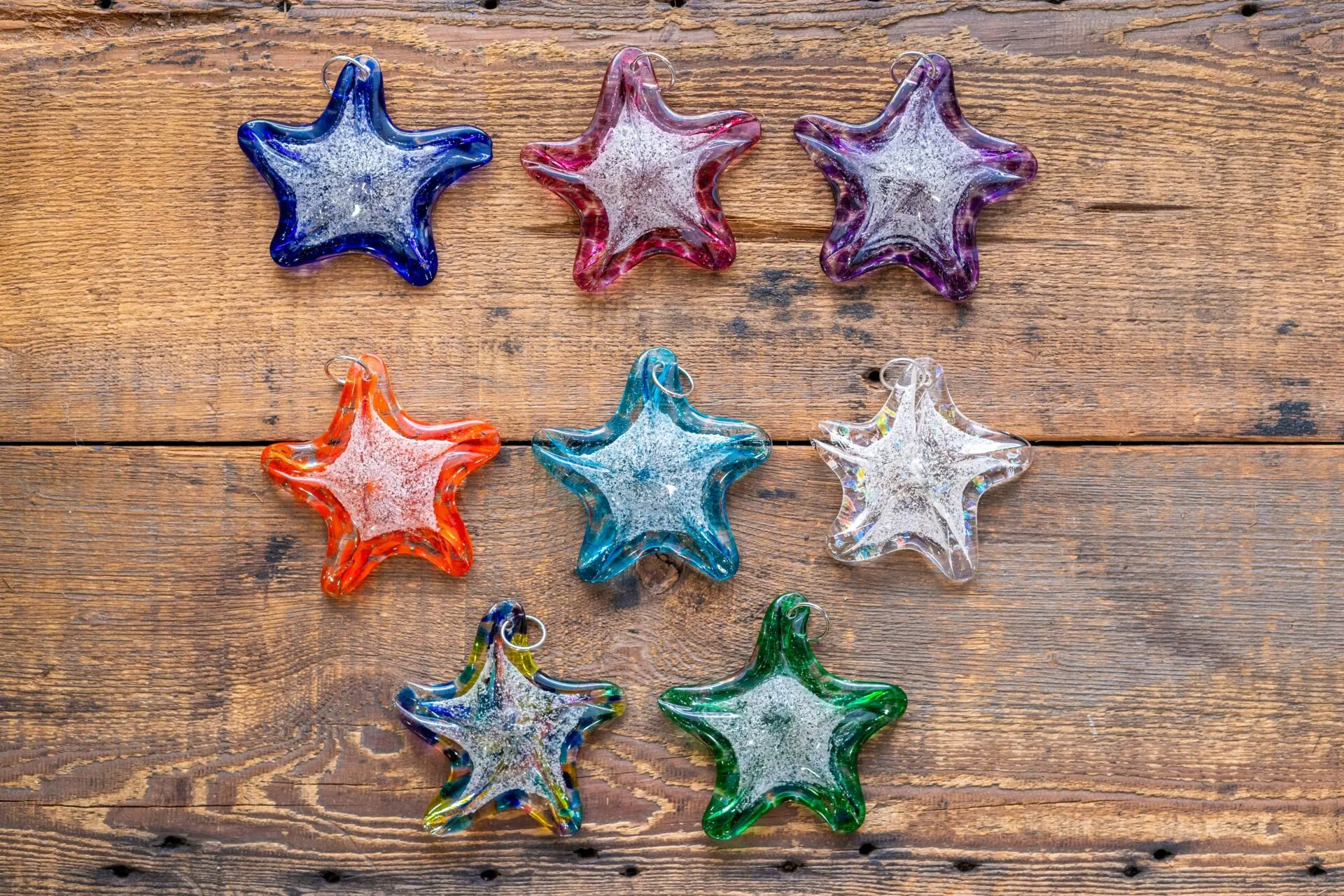 five different colored stars on a wooden surface